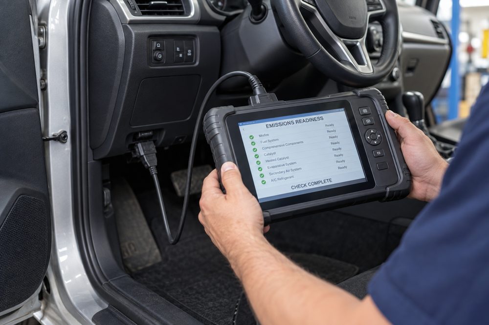 A diagnostic scan tool showing a completed emissions readiness check, all systems marked ready.