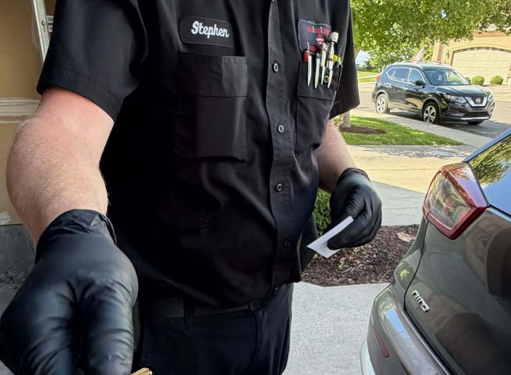 Stephen handing a completed vehicle back to a customer after a mobile emissions test.